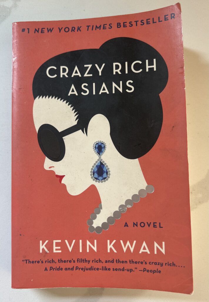 This is a photograph of the book Crazy Rich Asians by Kevin Kwan; sitting on a white countertop.