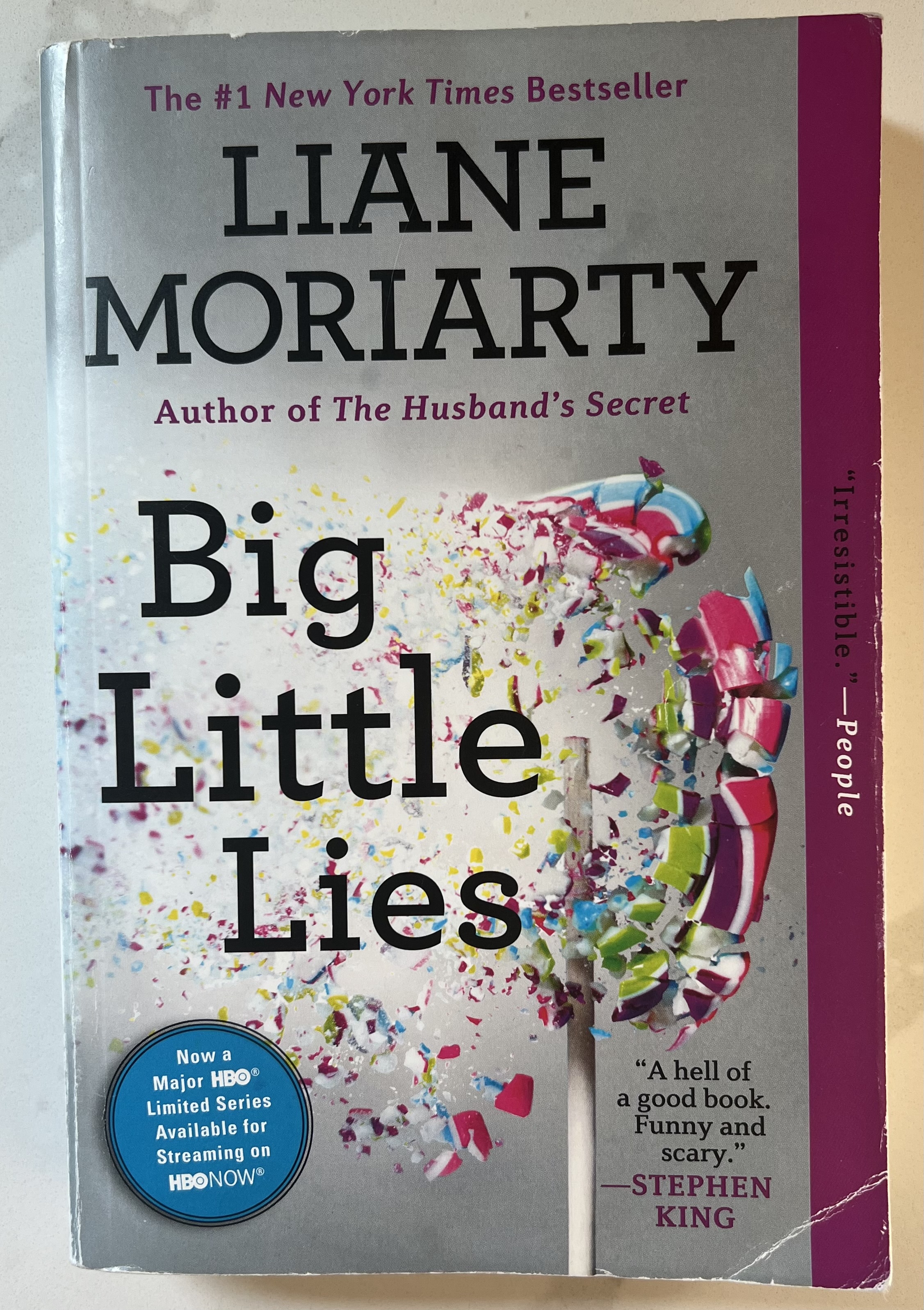 This is a photograph of the book Big Little Lies by Liane Moriarty; sitting on a white countertop.