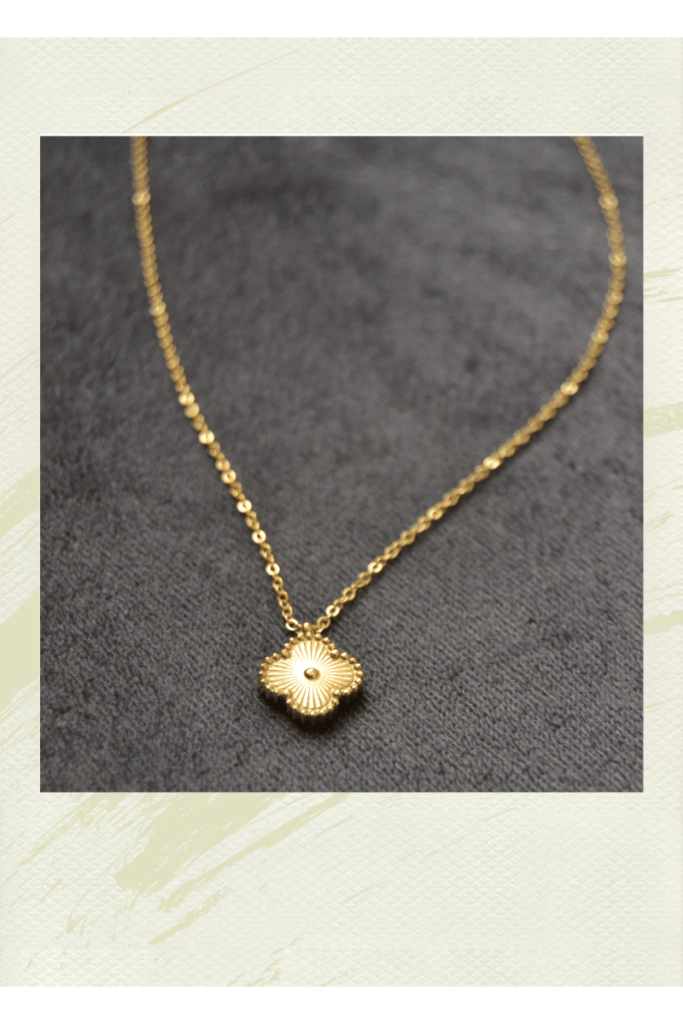 A photograph of a gold pendent necklace. Showing the new mom gift idea of giving personalize jewelry.